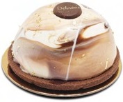 A mixture of white and brown shiny glaze half dome shape cake