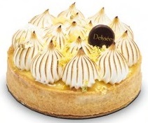 A flat round shape tart base with white golden swirls of maringue on top of it